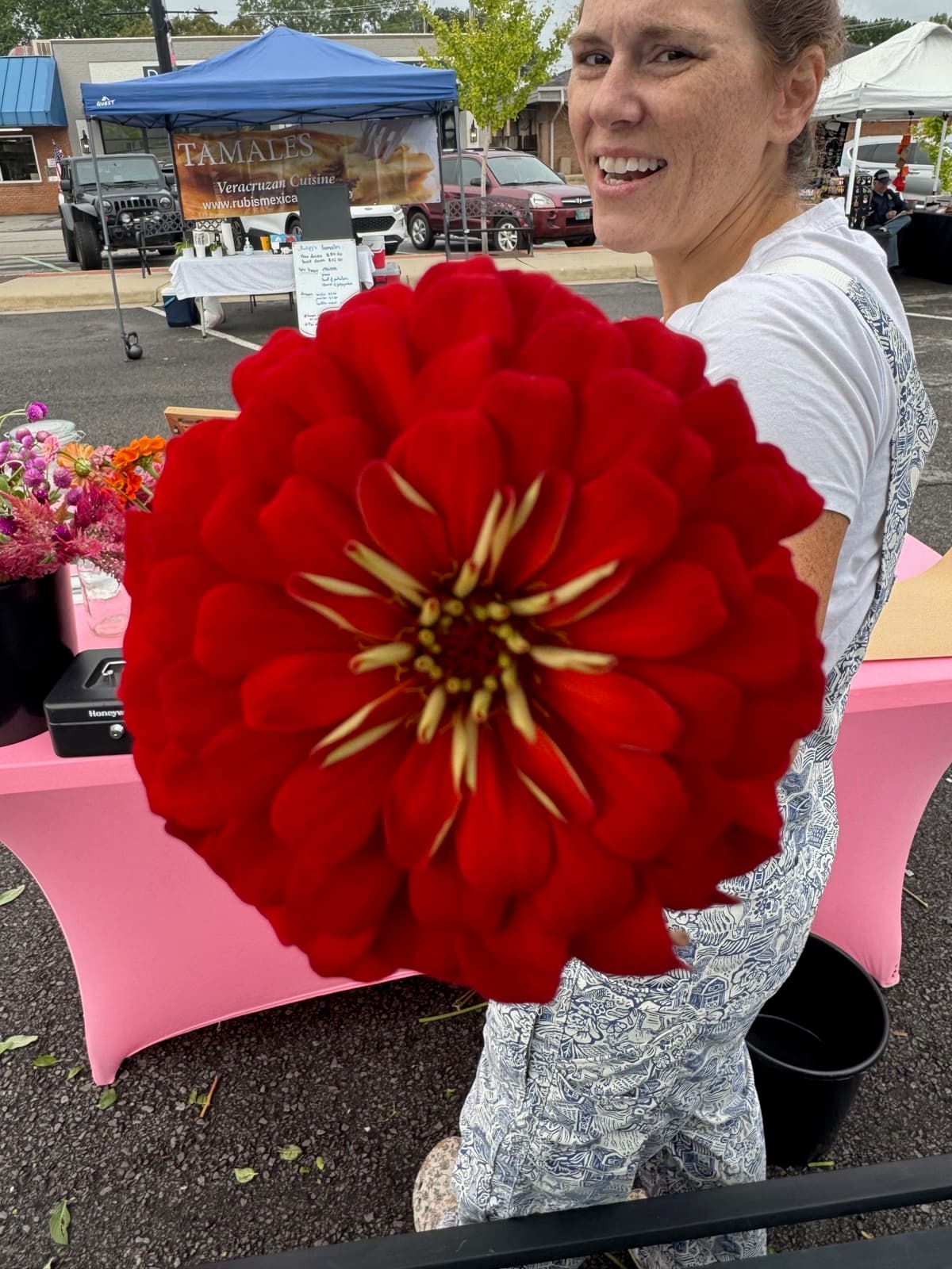 Lauren showing off a giant red zinnia bloom