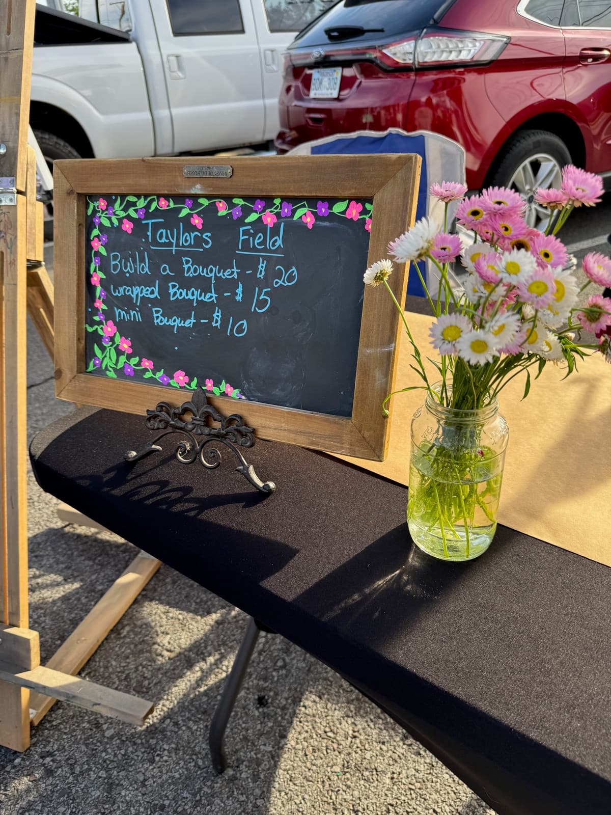 Taylor's Field chalkboard pricing sign with daisies