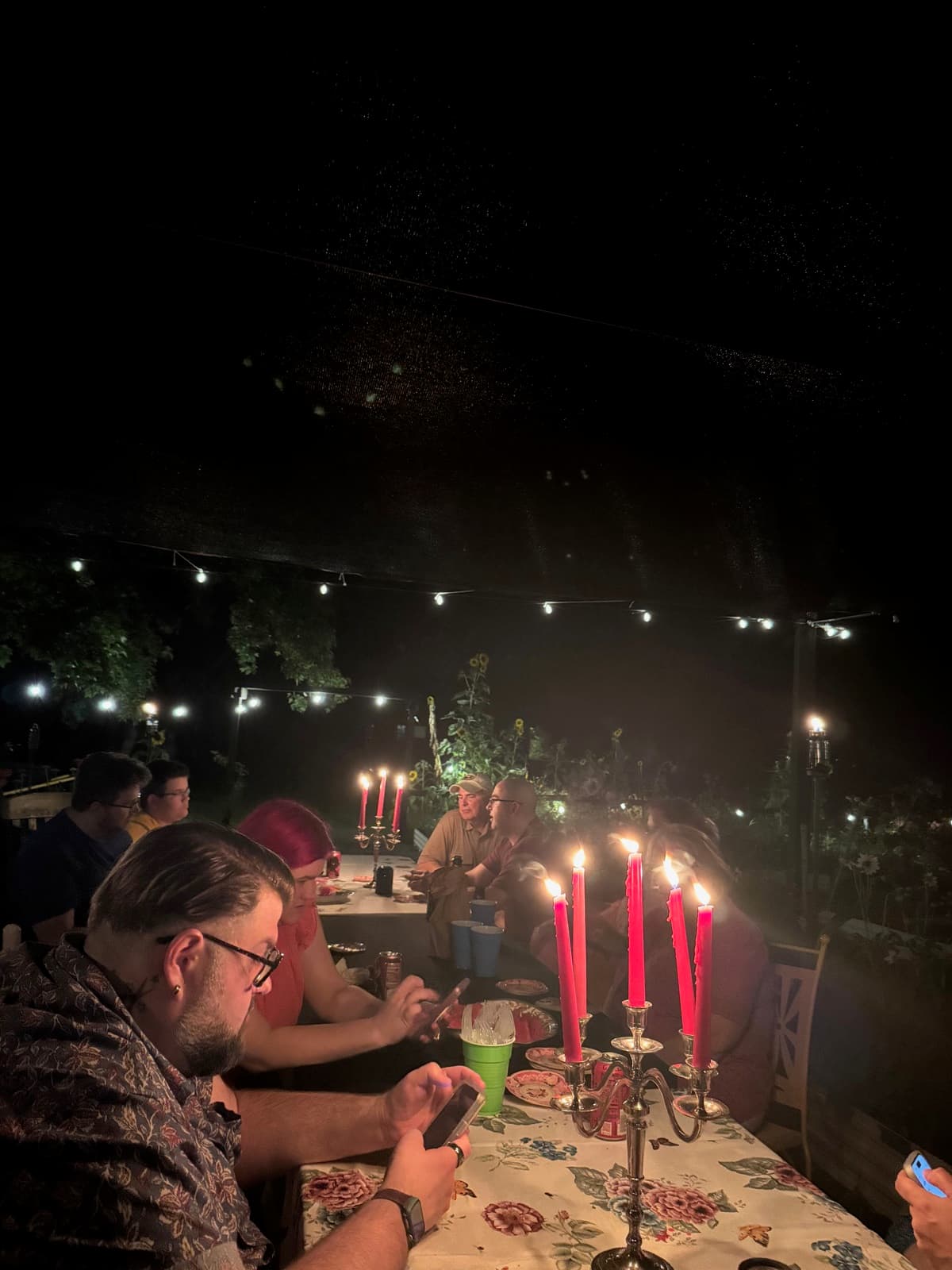 Garden dinner event with candles and string lights